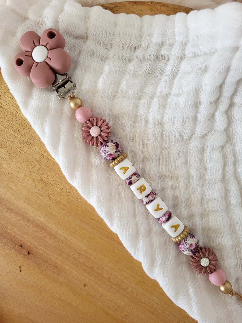 Attache-tétine fille marguerite rose