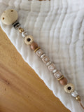 Attache-tétine marguerite beige
