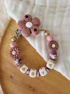 Attache-tétine fille marguerite rose