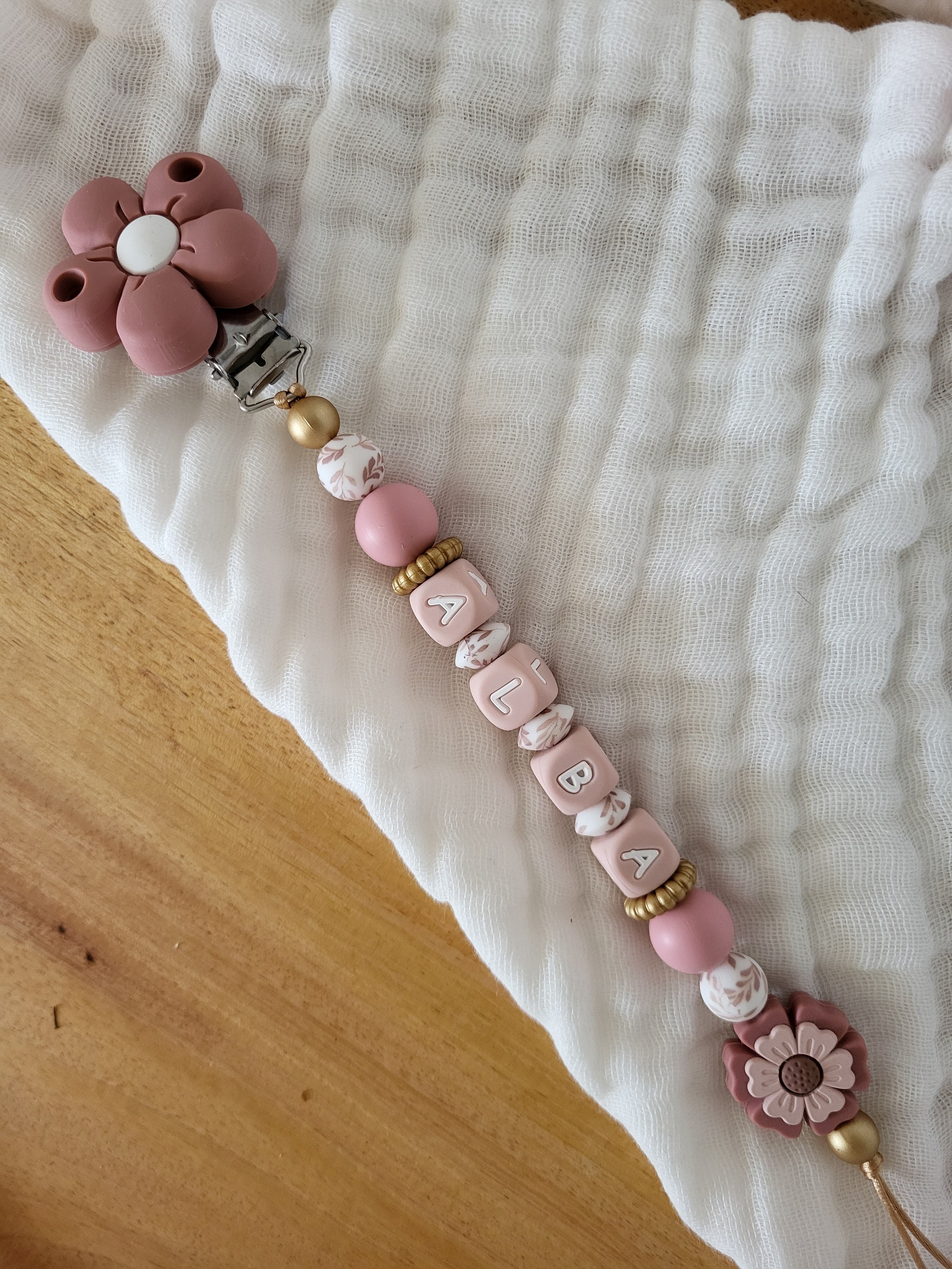 Attache-tétine fille marguerite rose